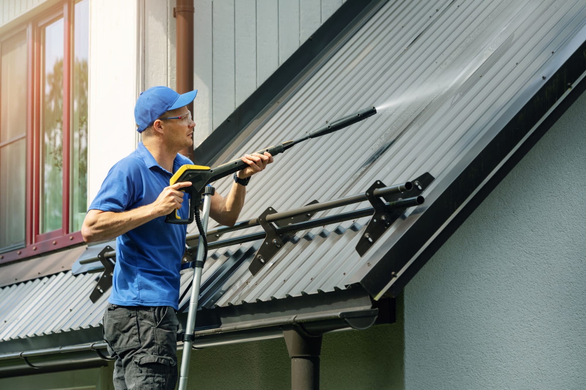 Curb Appeal Pro Services technician pressure washing a roof